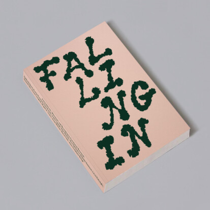 A light pink book on a grey background. In the cover there is the word 'Falling' in dark green color.