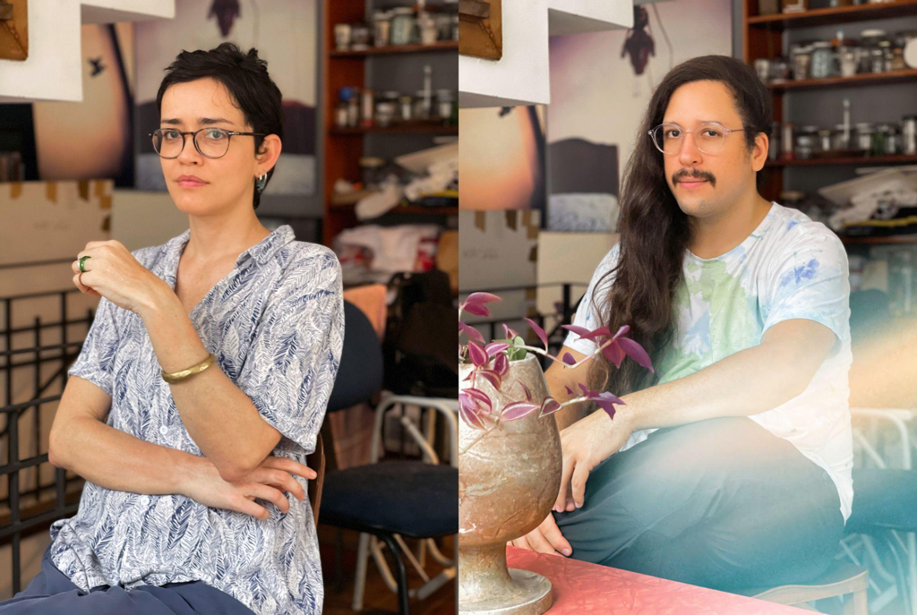 On the left is a light skinned person with dark short hair wairing glasses and on the right side a person with long dark hair and a moustache wearing glasses.