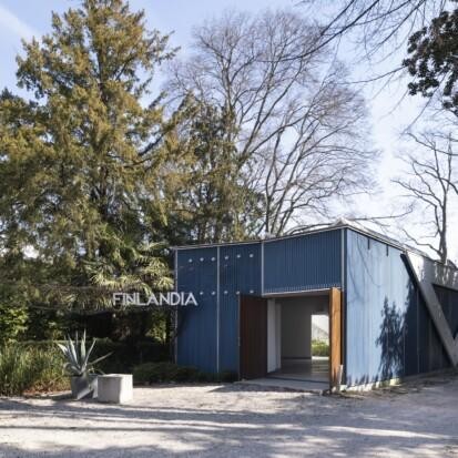 The blue wooden Finnish Pavilion on a sunny day in the Giardini park, Venice.